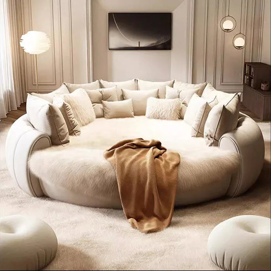 Large beige sofa with cushions and a blanket in a stylish living room.