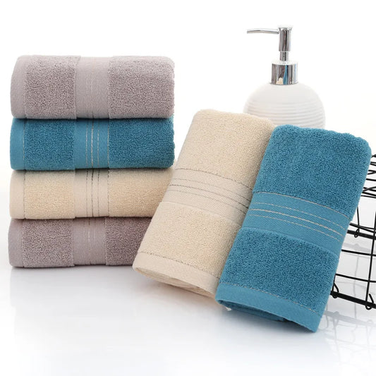 Stack of bath towels in various colors with a soap dispenser on a white background