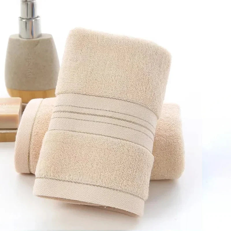 Beige towel with bath accessories on a white background