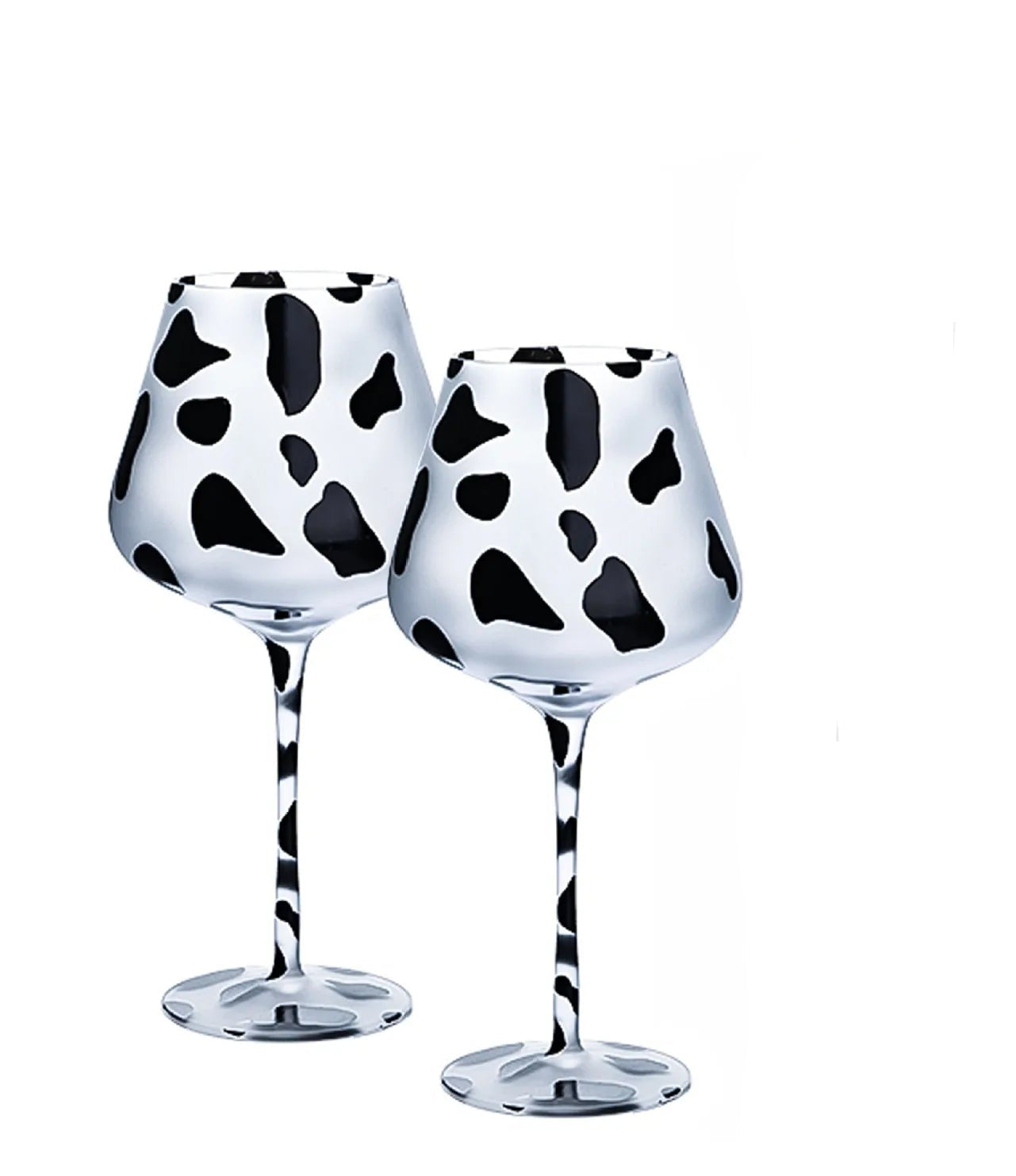 Two crystal wine glasses with black and white cow print pattern 